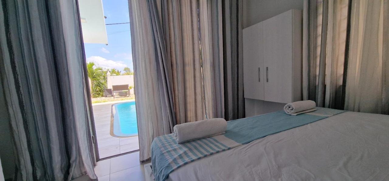 Bedroom with direct pool access at Luxora Villa Mauritius