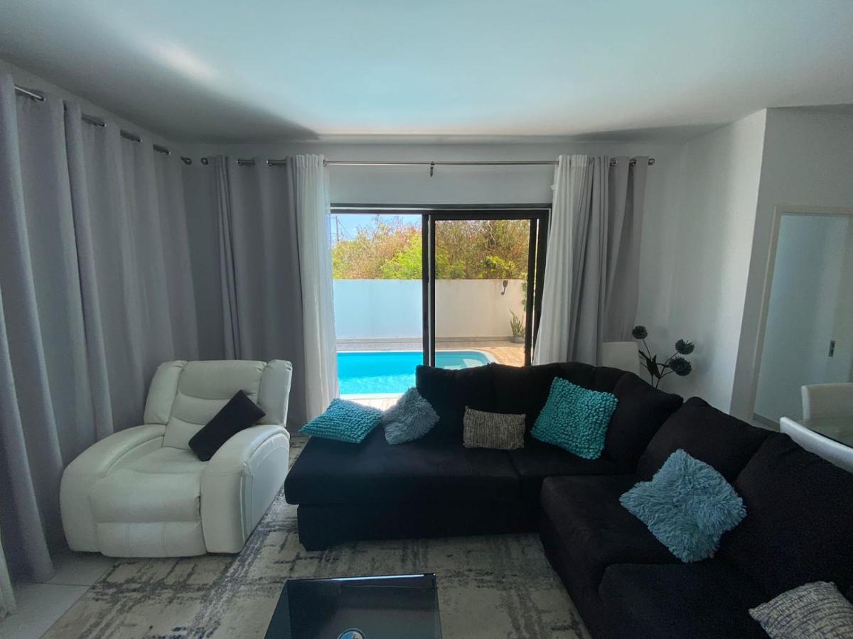 Living room opening onto pool at Luxora Villa Mauritius
