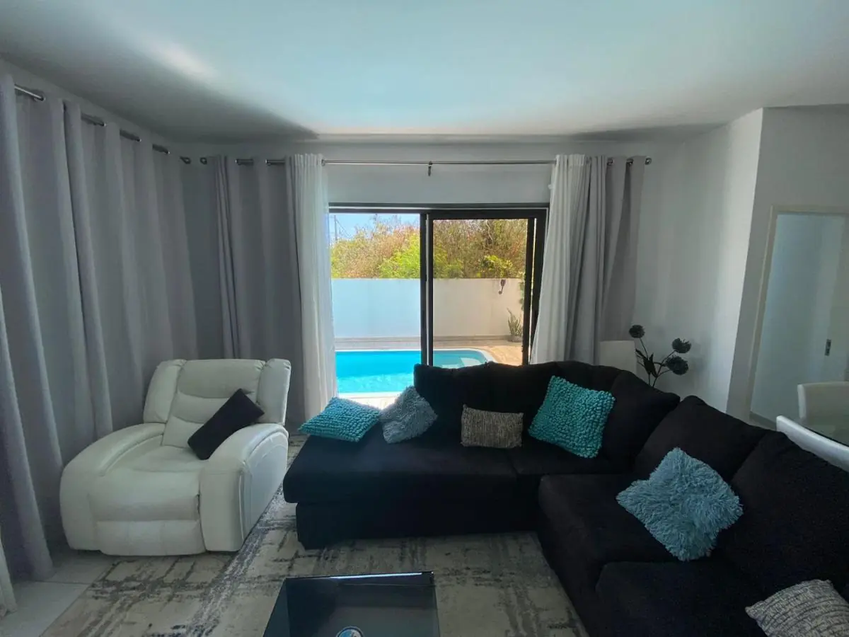 Spacious modern living room with direct access to the private pool at Luxora Villa, luxury villa Mauritius